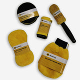 The AA 9 piece car cleaning kit includes yellow wash sponge, yellow wash mitt with black elasticated wrist band, yellow wheel brush with black handle, yellow cleaning cloths with black edging and black wax applicator/polishing pads with yellow stitching around the edges.
